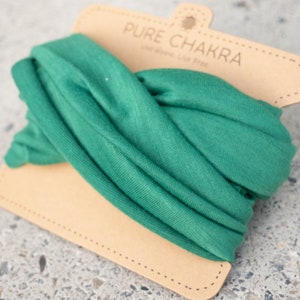 May include: A green fabric headband with a brown paper tag that says "PURE CHAKRA" and "Live alone. Live free."