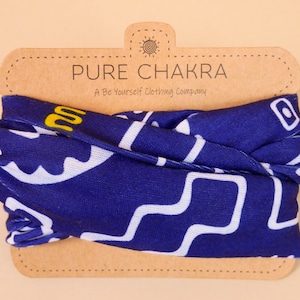 May include: A blue and white patterned neck gaiter with the text "PURE CHAKRA A Be Yourself Clothing Company" on a brown paper tag.