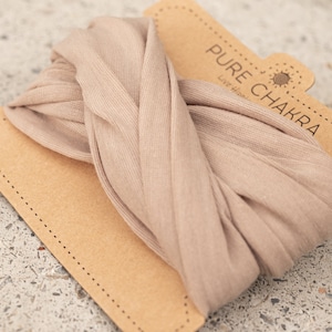 May include: A beige fabric headband with the text "PURE CHAKRA" and "Live Happy" on a brown card.