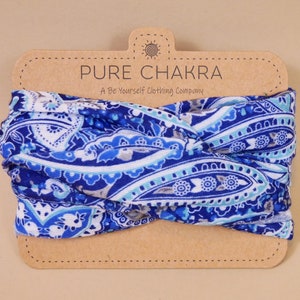 May include: A blue and white paisley patterned headband with a brown card that reads "Pure Chakra, A Be Yourself Clothing Company."
