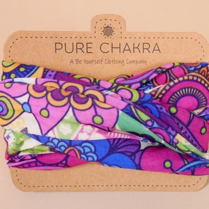 May include: A colorful patterned headband with a brown tag that reads "PURE CHAKRA A Be Yourself Clothing Company".