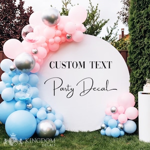 May include: A white circular party decal with the text "CUSTOM TEXT" and "Party Decal" in black script. The decal is decorated with pink, blue, and silver balloons, creating a festive atmosphere. The decal is on a green lawn.