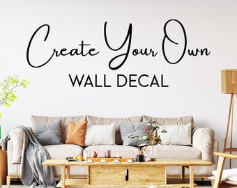 May include: A living room interior with a beige sofa, a wooden coffee table, and a wall decal that reads "Create Your Own Wall Decal".