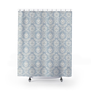 May include: A blue shower curtain with a white damask pattern.