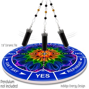 May include: A divination tool with a blue ceramic tile, 7.8 inches in diameter, featuring a colorful floral design and directional text. Three black crystal pendulums hang above the tile. Text on the tile includes "YES", "NO", "CAN'T SAY", and "REPHRASE".