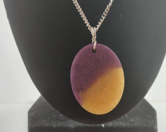 Purple and gold oval shapped pendant on silver chain