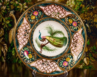 Polychromed dish with hand painted peacock decoration and gilt girdle. Originally from Belgium, typical of the 1950s