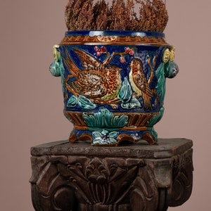 Old blue ceramic flowerpot with romantic decor couple of birds in relief, vintage majolica, Onnaing earthenware, circa early 20th century.