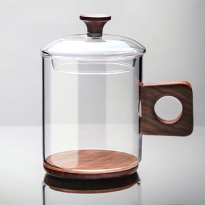 Glass mug with wood bottom and handle