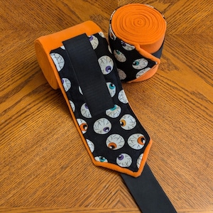 Polo Wraps, Glow in the Dark Eyes Flannel Fabric on Orange Fleece, Sets of 2 or 4, Halloween Horse Leg Wraps, Fun and Festive for all!