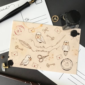 May include: A vintage-style postcard with a beige background featuring a repeating pattern of white birds carrying envelopes, keys, scissors, and feathers. The text "write something" is written in black cursive. The postcard also features a red stamp with the text "Station 9 3/4" and a round stamp with the text "The Tansy Patch Jessica Kaylor".