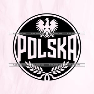 May include: A black and white circular design featuring the word "POLSKA" in bold, white letters. Above the text is a white eagle emblem, and below is a laurel wreath. The design is set against a light pink background.