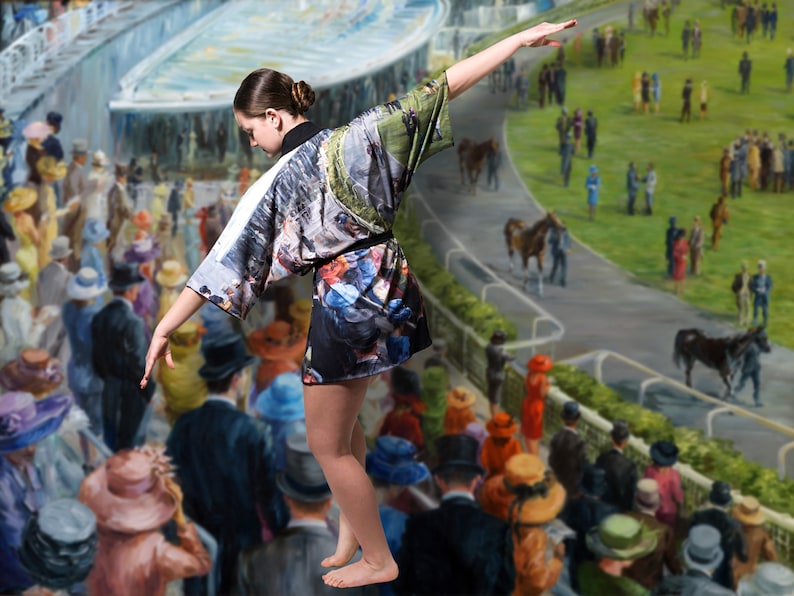 May include: A short kimono-style robe with a colorful print featuring a horse race scene. The robe is black with a white collar and sleeves. The background is a painting of a horse race with spectators.