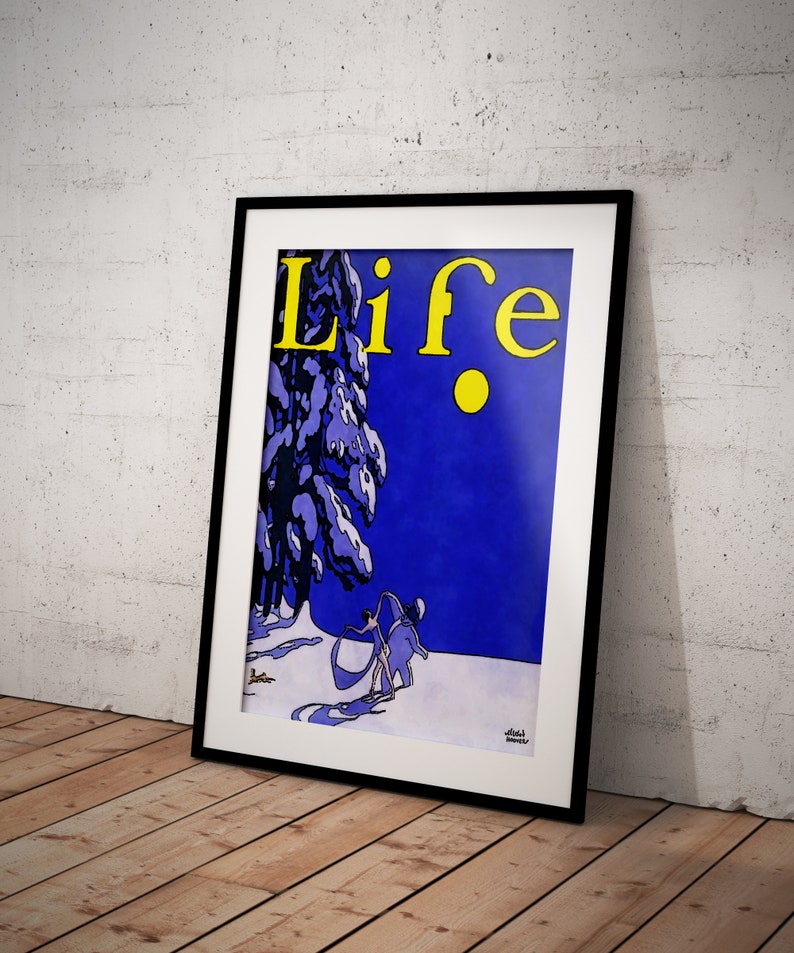 May include: Framed vintage "Life" magazine cover art. The artwork features a winter scene with figures skiing, a snow-covered tree, and the word "Life" in yellow. The background is a deep blue, and the frame is black.