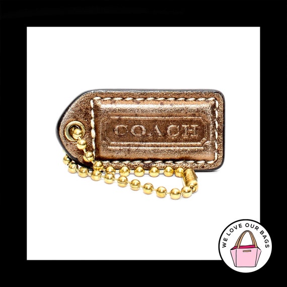 Coach gold metal hang tag deals