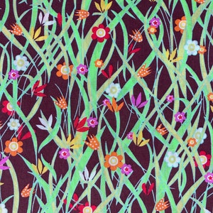 May include: A brown fabric with a repeating pattern of green, yellow, orange, red, white, and purple flowers. The flowers are stylised and have a retro look.