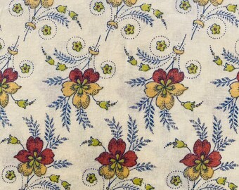 May include: A white fabric with a repeating pattern of red, yellow, and green floral designs. The flowers are stylized and have a vintage look. The background is a light cream color.