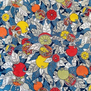 May include: A fabric pattern with a repeating design of stylized fruit, including oranges, lemons, and pomegranates, in red, orange, yellow, and green. The fruit is set against a backdrop of blue leaves and gray, dotted foliage.