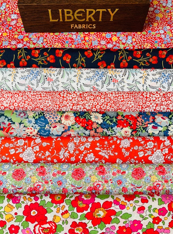 A vibrant ‘Miss Scarlet’ fabric bag. My packs consist of 8 different, red themed Liberty Tana Lawn pieces, cut to a generous size of 6”x 9”.