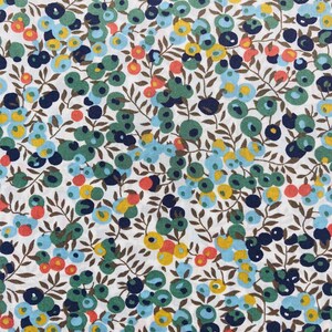 May include: A white fabric with a repeating pattern of blue, green, yellow, and orange circles on brown stems. The circles are arranged in clusters and resemble berries.