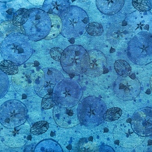 May include: Blue fabric with a repeating pattern of blue circles and leaves. The circles have a watercolour effect and the leaves are a darker blue.