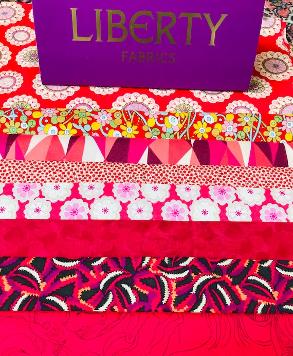 A Beautiful ‘Shades of Red’ fabric bag. Liberty Tana Lawn cotton pieces 6”x 9” in bags of 8.