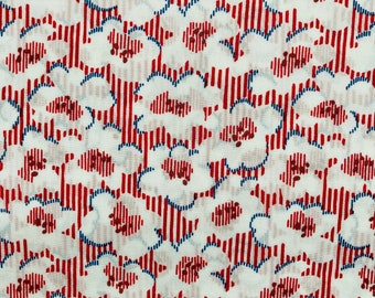 May include: White fabric with a red and blue striped pattern. The stripes are vertical and the fabric is covered in a repeating pattern of blue outlined white shapes.