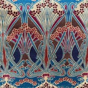 May include: A vintage fabric featuring an intricate Art Nouveau design. The pattern incorporates stylised floral motifs in shades of blue, brown, red, and cream on a beige background.