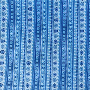 May include: Blue and white striped fabric with a repeating geometric pattern. The pattern includes small flowers, squares, and other abstract shapes.