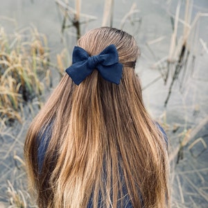 フレンチバレッタに付いた大きなリネンのヘアリボン、ネイビーブルー。クラシックでエレガントな女性、女の子、子供用のヘアアクセサリー。かわいいギフトボックスに入ったフレンチネイビー