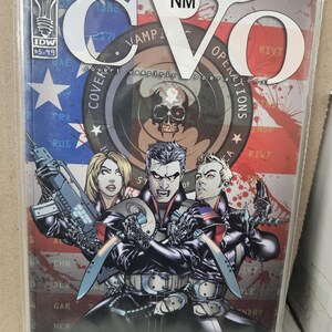 May include: A comic book cover featuring a group of characters in black tactical gear, holding weapons. The cover is titled "CVO: Covert Vampiric Operations" and features a red, white, and blue American flag background.