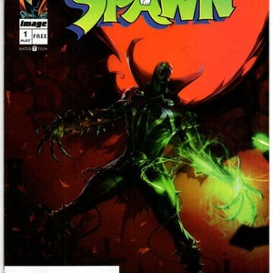 May include: A comic book cover featuring Spawn, a green and black superhero with a cape, holding a glowing green hand. The cover is red with the title "Spawn" in green and black letters. The text "Free Comic Book Day" is at the top of the cover.
