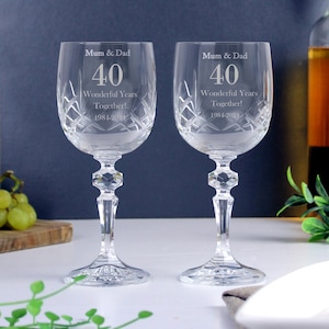 May include: Two clear crystal wine glasses with etched designs. The glasses are engraved with the text "Mum & Dad 40 Wonderful Years Together! 1981-2021".