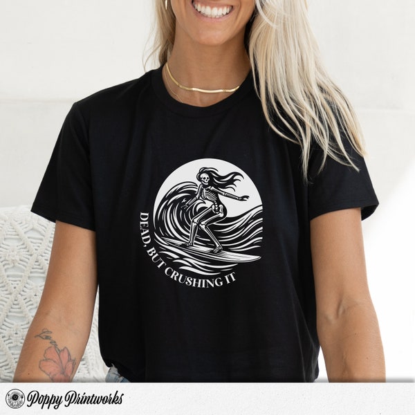 Female Skeleton Dark Humour Cropped T-Shirt: "Dead, But Crushing It", Bella+Canvas 8882, Femme Skeleton Surfing, Funny T-Shirts for Women