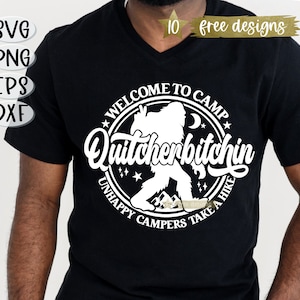 May include: Black t-shirt with a white graphic design of a Bigfoot character in a circle with the text "Welcome to Camp Quitcherbitchin Unhappy Campers Take a Hike".
