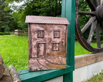 "House" mailbox with newspaper roll