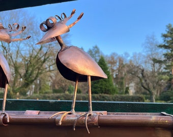 Family bond bird made of copper on gutter