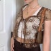 Lori reviewed Y2K Floral Lace & Front Tie Designed, Short Sleeve, V-Neck, Sexy, Transparent, Mesh Crop Top / Streetwear / Vintage / Retro / Y2K Aesthetic