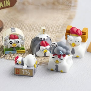 May include: A collection of whimsical chicken figurines, each with unique designs. One rests on a block with "1%" on it, while others feature business attire and various headwear. The figurines are white with red combs and yellow beaks.
