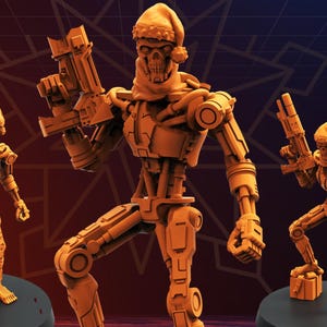 May include: Three orange-colored robot figurines, each holding a gun and wearing a Santa hat and scarf. The central figure stands on a gift box, while the others are on black circular bases. The robots have detailed mechanical features.