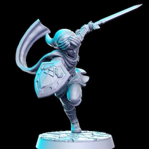 May include: A gray plastic figurine of a character from the Legend of Zelda video game series. The character is wearing a tunic, pants, and a cape. The character is holding a sword and shield. The figurine is standing on a gray base.