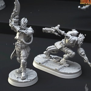 May include: Two gray 3D printed miniature figures of human cyborgs with mechanical parts and weapons. The figures are posed in action stances and are standing on circular bases. The text "Human Cyborgs" and "547" are printed below the figures.