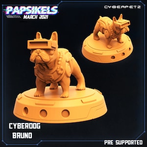 May include: A 3D printed model of a French Bulldog wearing a futuristic helmet and armor. The model is painted in a light orange color and is standing on a circular base. The text "CYBERDOG BRUNO" is printed below the model. The text "PRE-SUPPORTED" is printed in the bottom right corner of the image.