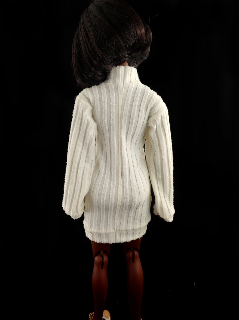 May include: A white ribbed sweater dress with long sleeves and a mock neck.
