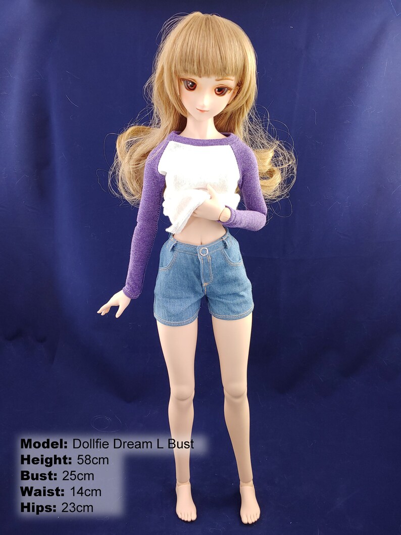 May include: A dollfie dream doll with long brown hair, wearing a white and purple shirt and blue denim shorts. The doll is 58 cm tall, has a 25 cm bust, 14 cm waist, and 23 cm hips.