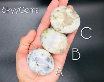 May include: Three white, gray, and light green agate palm stones, labeled A, B, and C. The stones are smooth and polished.