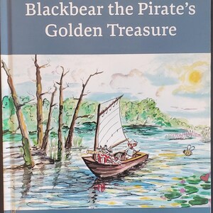 May include: A children's book cover titled "Robbie Raccoon and Blackbear the Pirate's Golden Treasure." The illustration shows a sailboat with animal characters sailing on a lake. The book is written by David Doyon and illustrated by Valerie Doyon.
