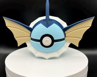 May include: A blue and white 3D printed Pokemon figurine of a water-type Pokemon with a large fin on its head and two large fins on its sides. The Pokemon has a Pokeball design on its chest.