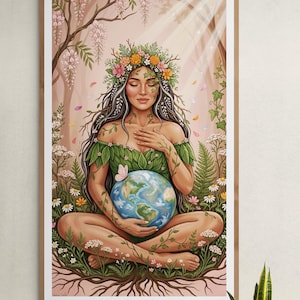 May include: A framed wall art print depicting a figure with long dark hair and a floral crown, sitting in a cross-legged position. The figure wears a green leaf-patterned top and holds a globe, surrounded by flowers, vines, and tree roots.