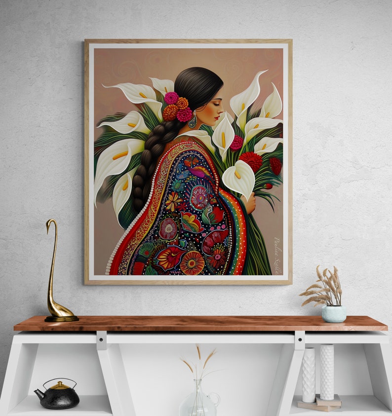 May include: A painting of a woman wearing a colourful embroidered dress and holding a bouquet of white calla lilies. The background is a soft peach colour.